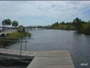 small boats under foot bridge at jenkins creek