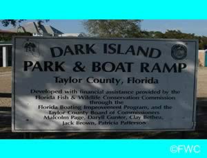 dark island park and boat ramp entrance sign