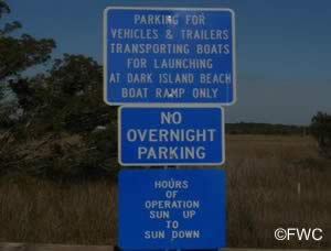signs at dark island park and boat ramp